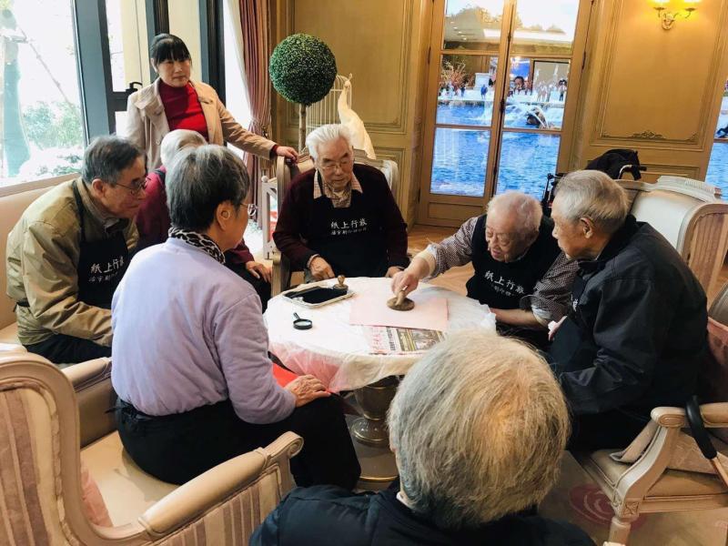 Chinese New Year calligraphy with Orpea residents, image 2 of 4