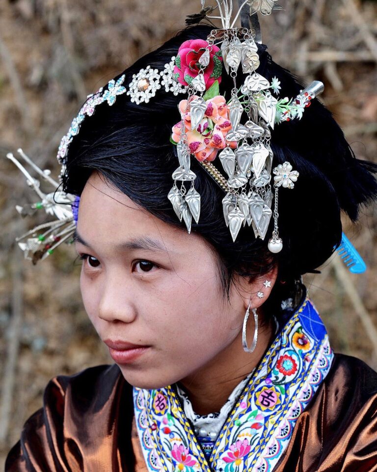 For the yearly Lusheng Competition Festival, Miao women put their hair in beautiful buns, ornamented with…