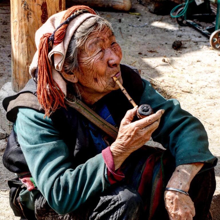 Lisu woman smoking her pipe, near Bingzhongluo, Yunnan, southwest China