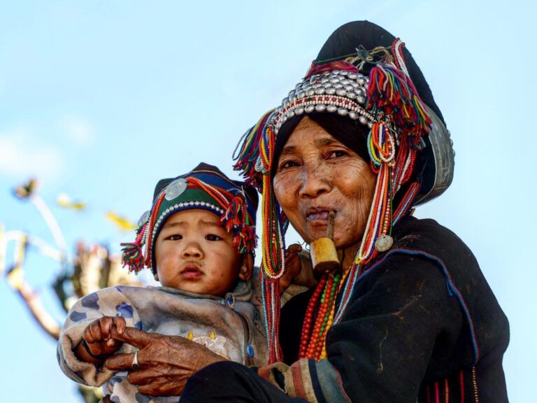 Grandmother and grandchild from the Aka “sharp-headed” tribe, itself a part of the larger Hani ethnic…