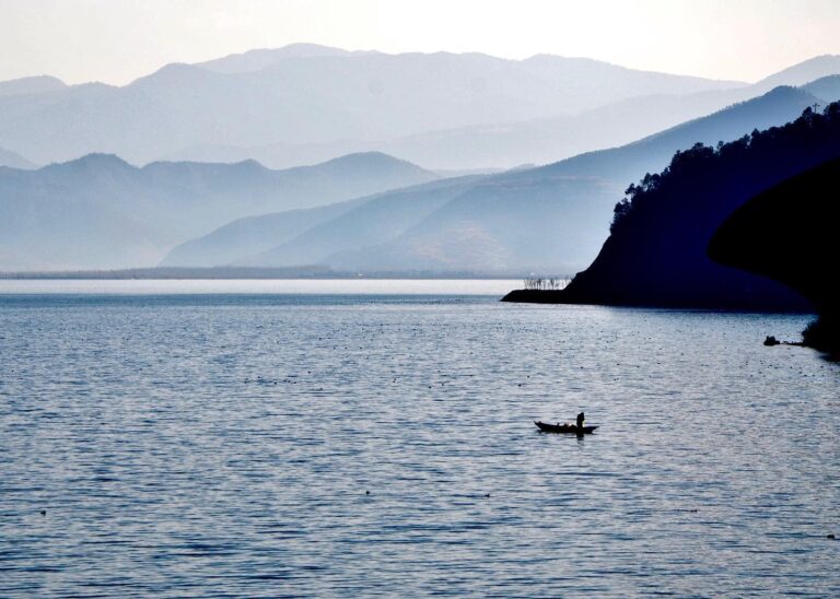 Fishermen on Lake Lugu. With the undefined colours, the mist and the shadows, the first picture makes me…, image 1