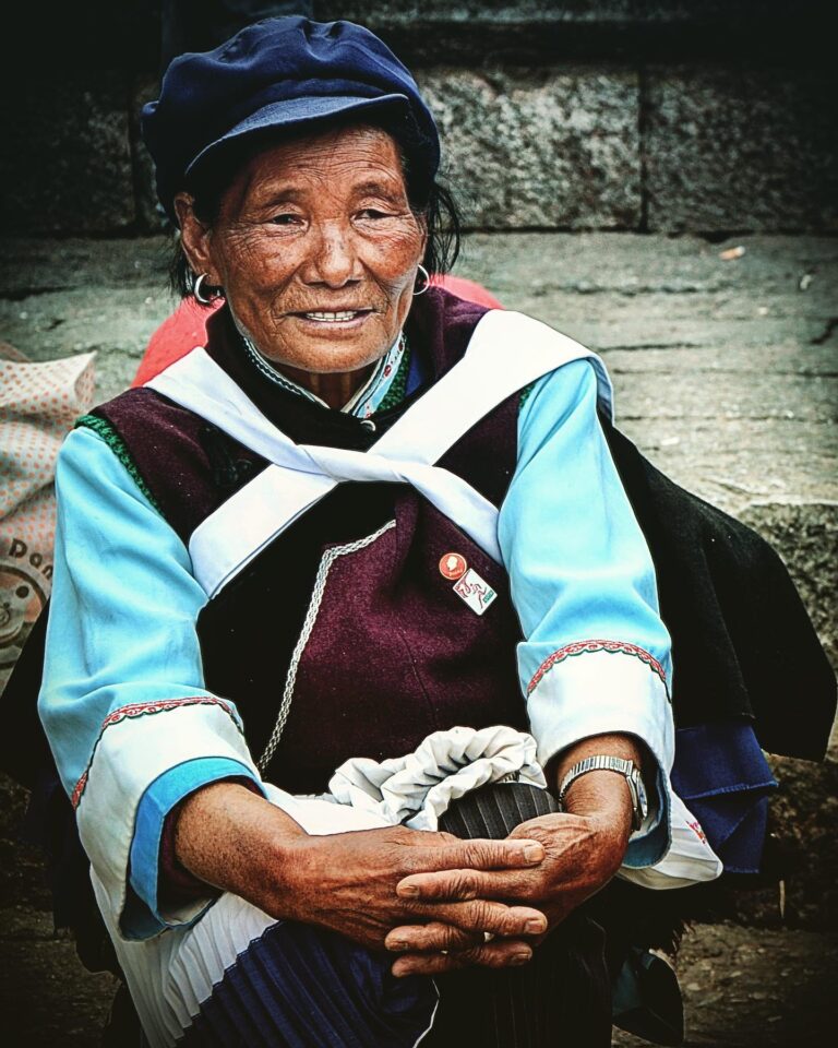 Naxi woman resting on Lijiang Old Town’s central square