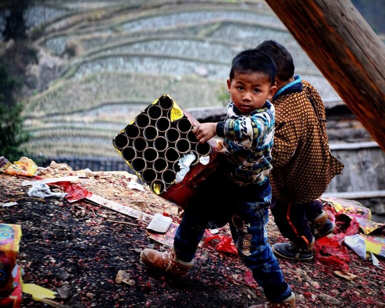 Miao kids setting off fireworks and firecrackers to celebrate the Lusheng Festival