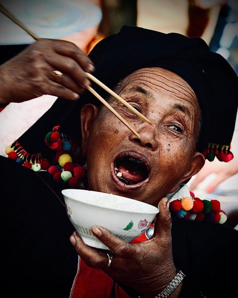 Bon appétit! De’ang woman enjoying her lunch after the Ganba ceremony