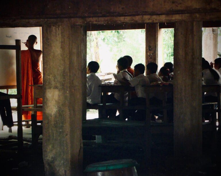 Monk teaching English to young Cambodian students