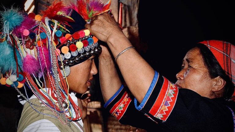 Mother helping her daughter to get ready for the Hani new year celebration, image 1