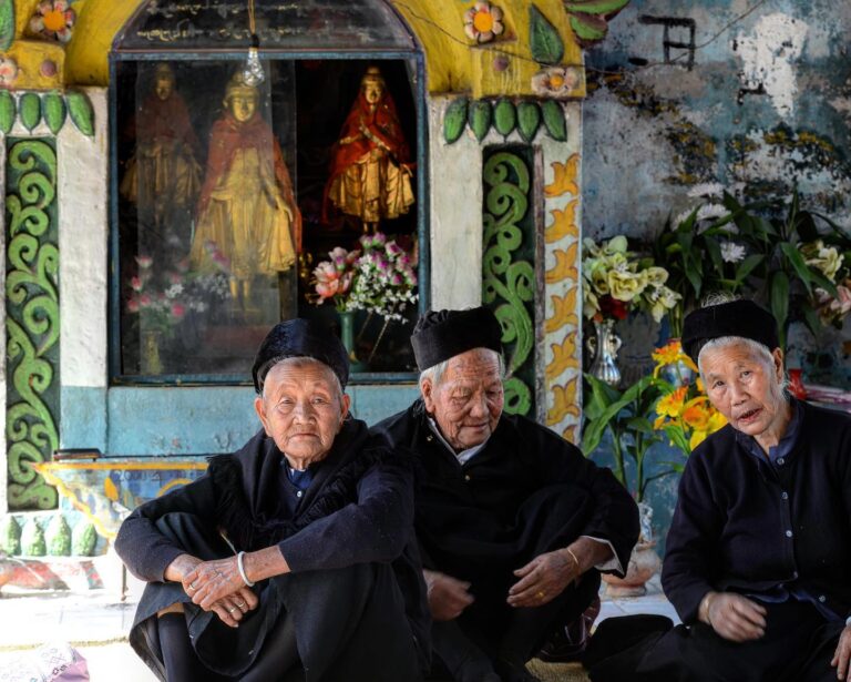 Dai elderly women having a rest close to the gods’ altar at the Ganba festival