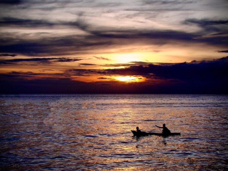 Sunset on the Celebes Sea, and Bajau fisherman about to come home