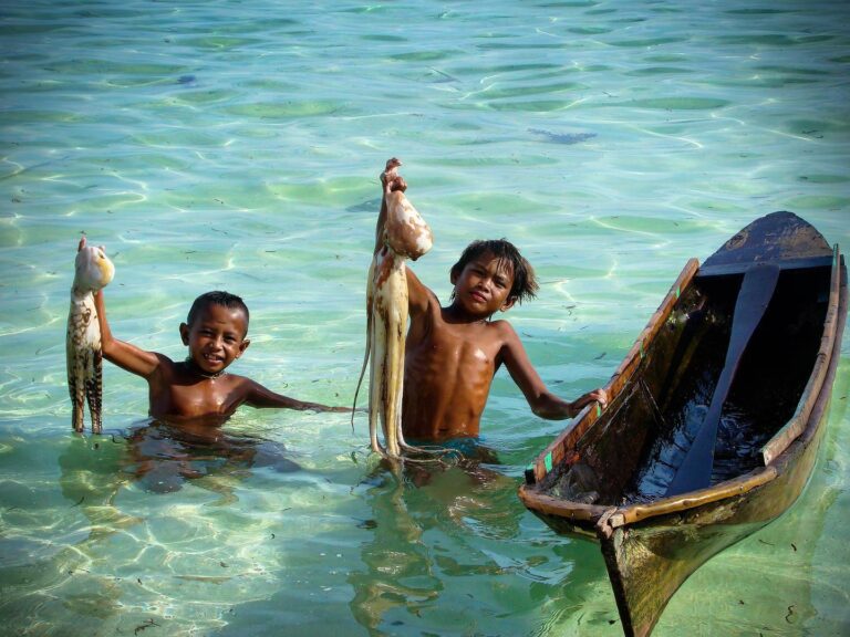 Bajau Brothers with their Boat on a Beach of Borneo