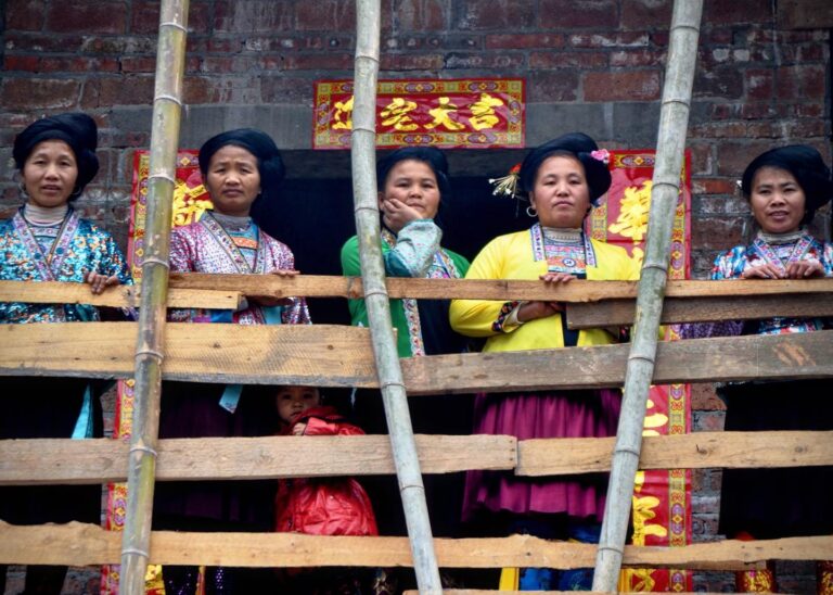 Miao women watching the yearly celebration of the Lusheng Festival from their balcony