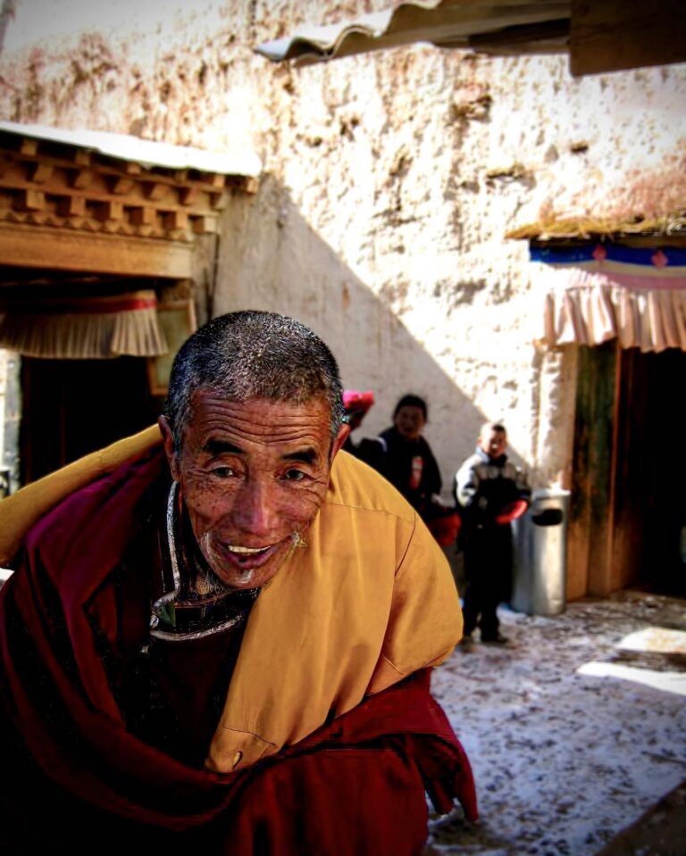 Tibetan Buddhist monk from the yellow-hat Gelugpa sect, on his way to the daily prayer at the Ganden…