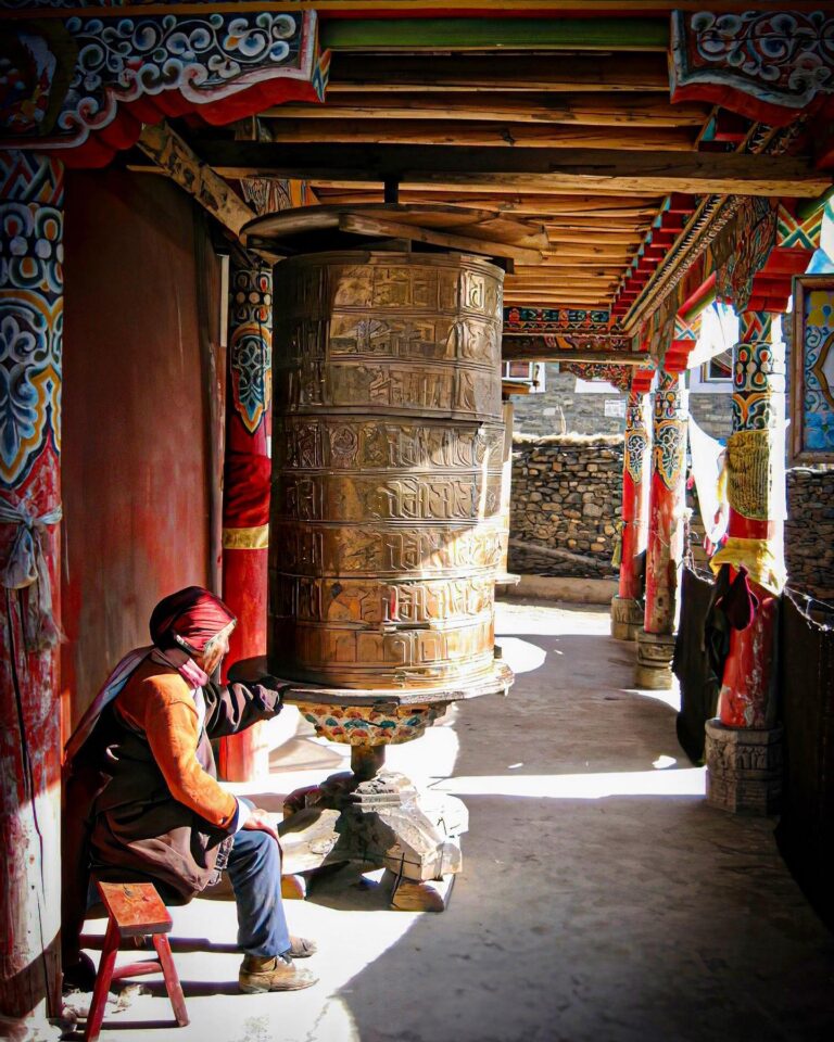 Believer spinning a prayer wheel at the Lhagang Gompa monastery, in Tagong, Sichuan