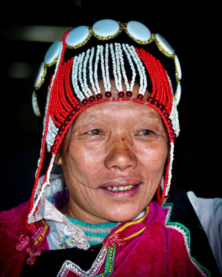 Nu woman from the Salween Valley, with her typical headgear made of coral pearls and bones