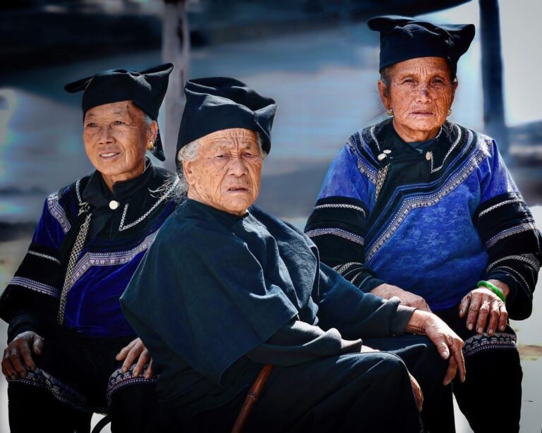 Hani women in Honghe, Yunnan, busy with probably one of their favourite occupations: watching people come and go