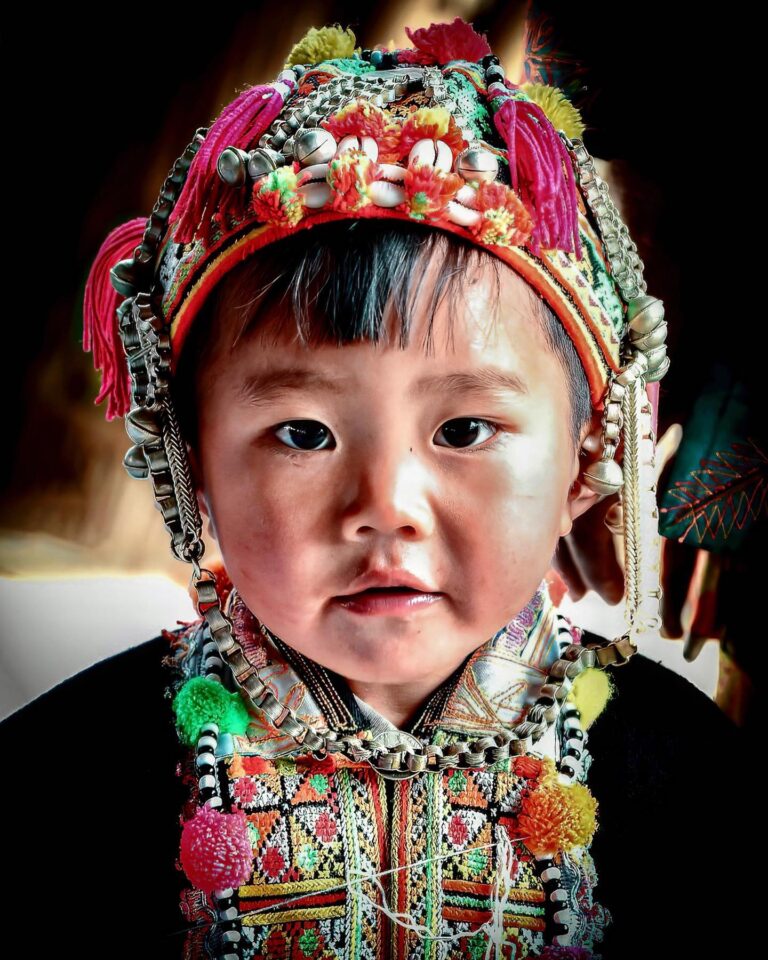Child from the “Red-headed” branch of the Yao ethnic minority, with a typical kid headgear