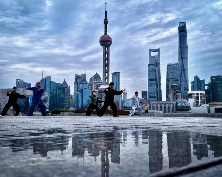 Moody Morning Taichi on the Bund, in Shanghai, with a view of the Pudong Business District skyline