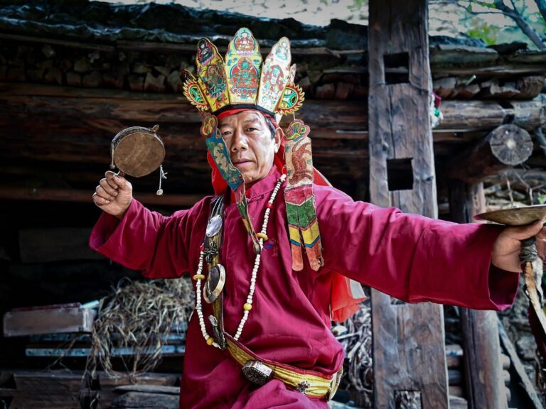 Yingzha Cili, one of the last remaining 11 Great Dongbas in China, wearing his ritual outfit