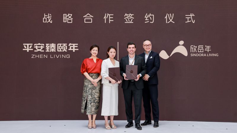Representatives of Zhen Living and Sindora Living holding signed partnership agreements