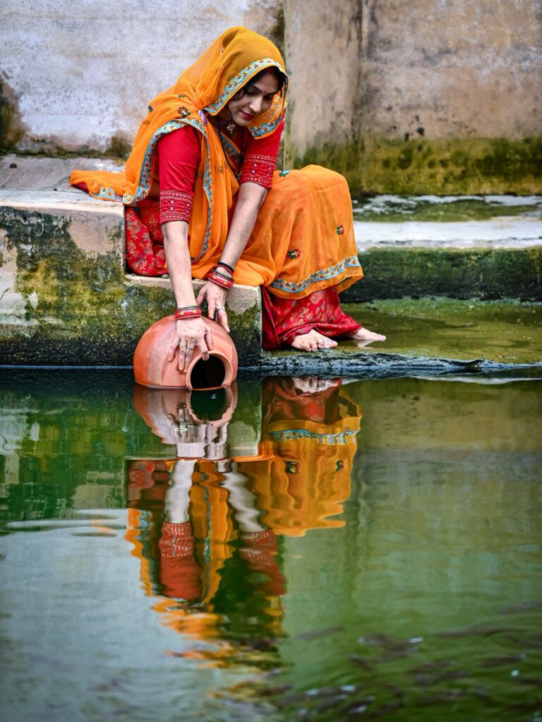 Drawing water from the Amer Stepwell, also called Panna Meena ka Kund, Jaipur, Rajasthan