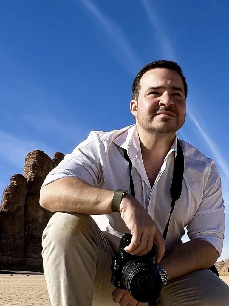 Nathaniel Farouz with his camera at a historic site in Saudi Arabia.
